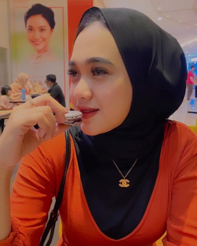 foto gadis hijaber cantik sedang makan roti foto gadis hijaber cantik sedang makan roti